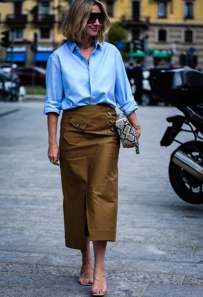 Woman wearing an elegant icy blue outfit with silver accessories, inspired by the Cool Blue Pinterest trend 2026.