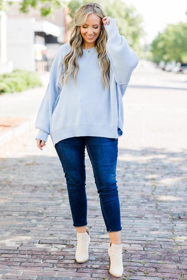 Woman wearing an elegant icy blue outfit with silver accessories, inspired by the Cool Blue Pinterest trend 2026.