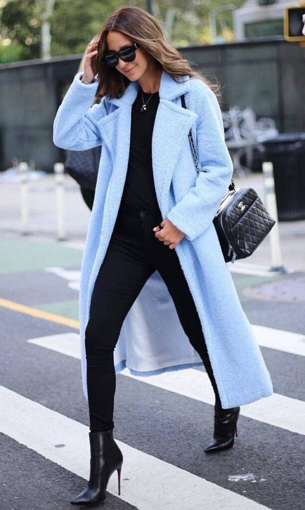 Woman wearing an elegant icy blue outfit with silver accessories, inspired by the Cool Blue Pinterest trend 2026.