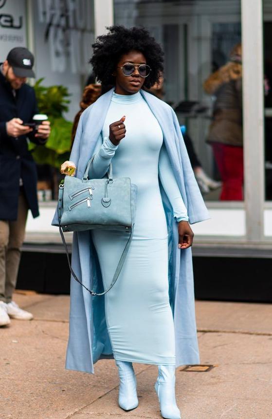 Woman wearing an elegant icy blue outfit with silver accessories, inspired by the Cool Blue Pinterest trend 2026.